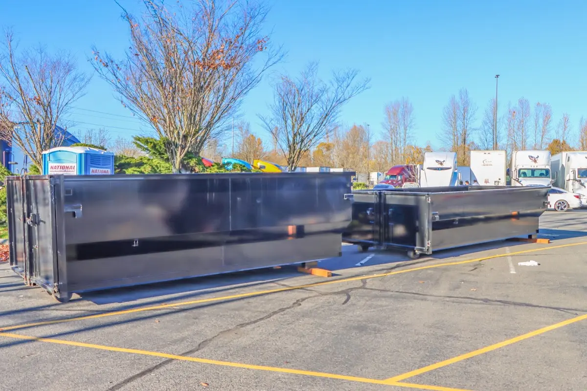 Professional dumpster rental service with roll-off container on residential driveway in Sheboygan